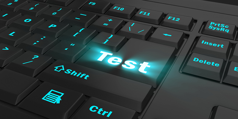 blue glowing Test key on black keyboard