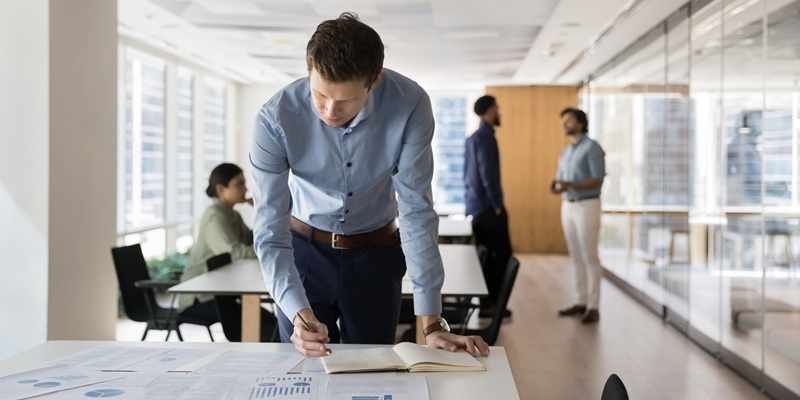 Focused busy young company owner man assessing business risk