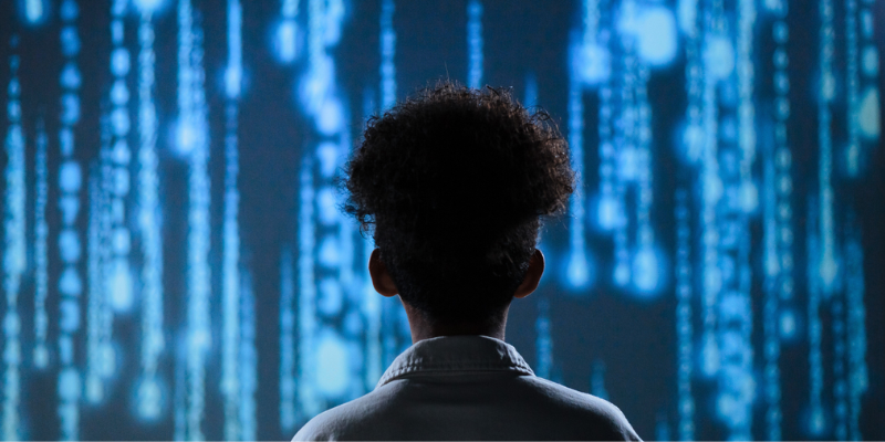 young man staring at streaming data, illustrating AI risks for businesses