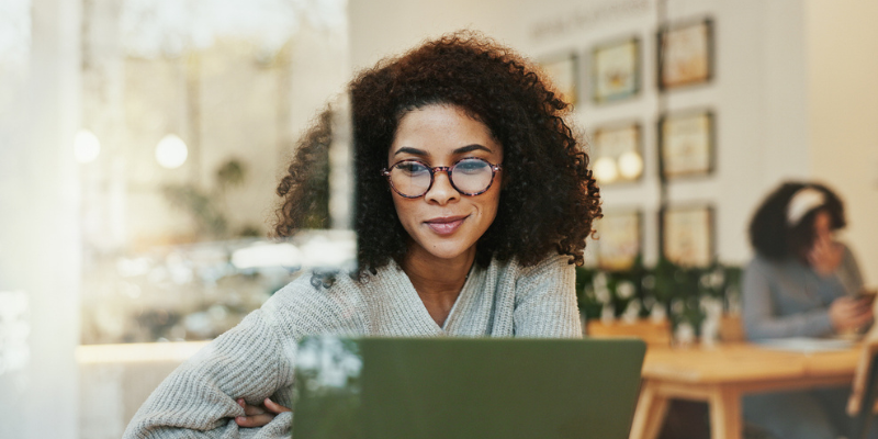 remote employee in coffeeshop evaluating VPN vs proxy options to connect